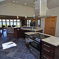 Expansive kitchen island, living area behind, then the view!